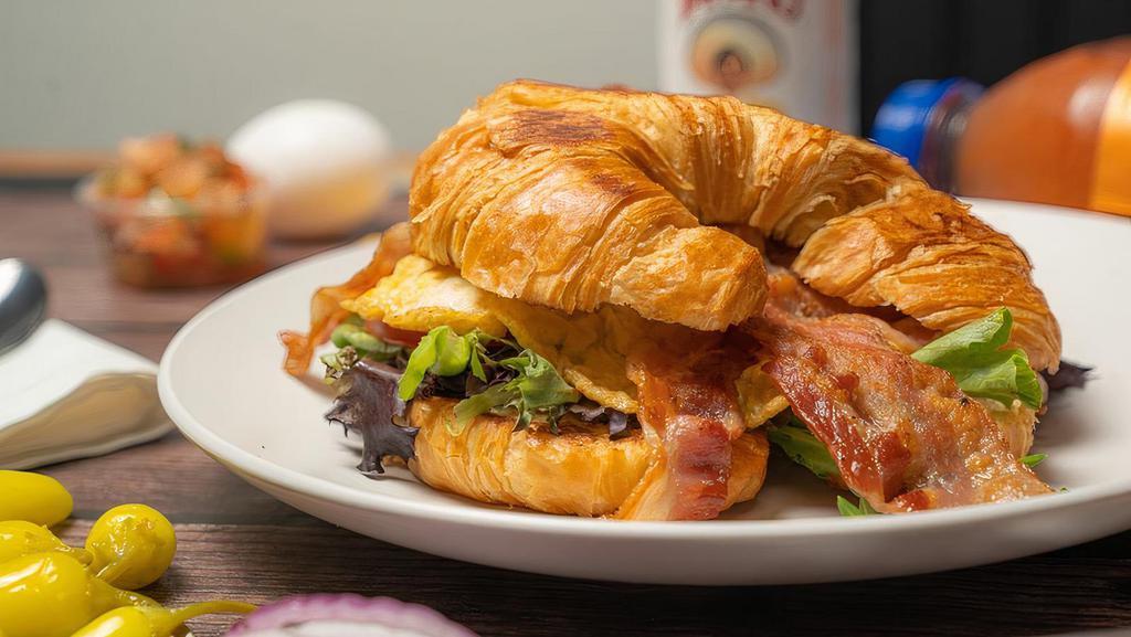 Croissant Sandwich · Fried egg, choice of meat, lettuce, tomato, American cheese, and mayo.