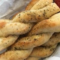 Breadsticks · Baked with fresh pizza dough, topped with parmesan cheese and herbs.