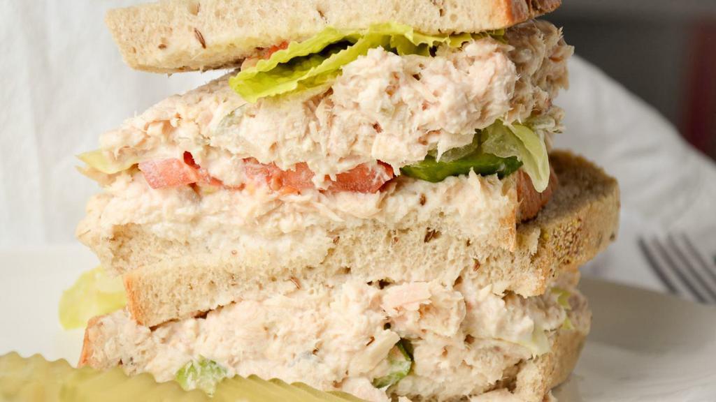 Tuna Sandwich · Our homemade tuna salad, tomato, cucumber, lettuce on toasted French roll and a side of pickles and potato salad.