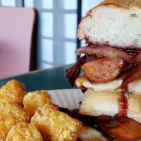 Cajun Cristo Sandwich & Tater Tots · Smokey Andouille sausage, two strips of bacon, sautéed onions and melted Habanero Jack chees...