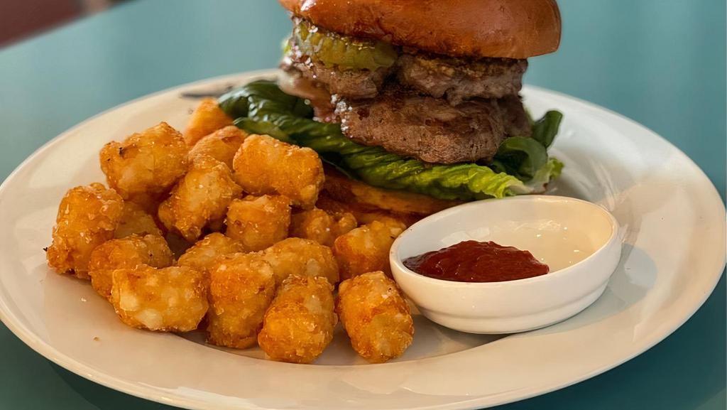 Half Pound Patty Cheeseburger & Tater Tots  · Two 4 ounce angus chuck beef patties with melted sharp cheddar cheese, lettuce, tomato, onion, tart pickles, and house-made mustard on a buttered toasted bun. Comes with a side of our crispy tater tots and lula's tot sauce. Add two Bacon strips/Egg/and or avocado upon request for a additional fee.