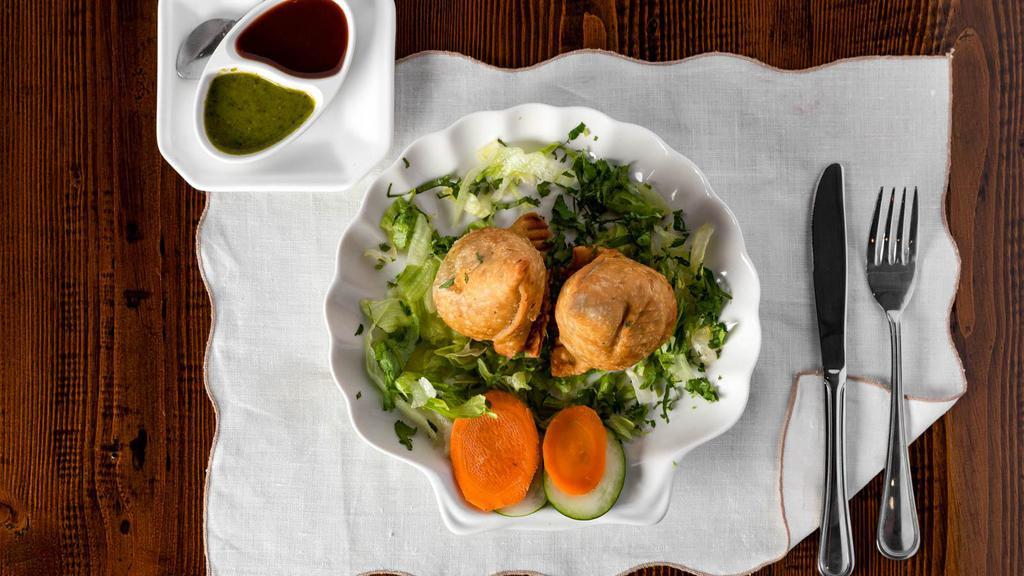 Vegetables Samosa · 2 pieces. Deep fried pastry stuffed with spices potatoes and green peas. Serve with tamarind chutney.
