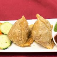 Lamb Samosa · 2 pieces. Deep fried pastry stuffed with spiced ground lamb and green peas. Serve with tamar...