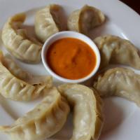 Chicken Momo · 10 pieces. Steamed dumplings filled with minced chicken, onion, cilantro and herbs and spice...