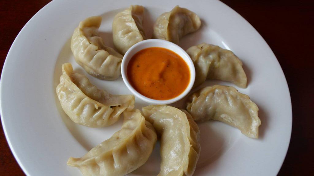 Chicken Momo · 10 pieces. Steamed dumplings filled with minced chicken, onion, cilantro and herbs and spices. Served with special Himalayan sauce.