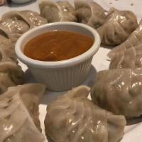 Vegetables Momo · 10 pieces. Steamed dumplings filled with minced cabbage, fresh spinach, cashew nuts, mushroo...