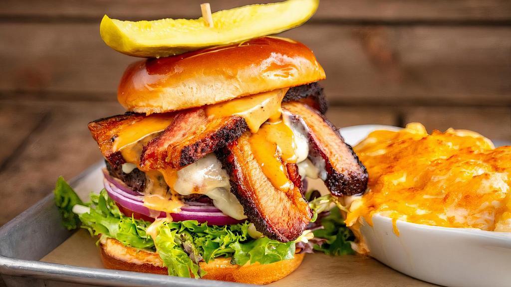 Rodeo Burger · 1/2 pound of USDA Angus short rib, brisket, and ground chuck, mesquite grilled and topped with Tillamook white cheddar, rodeo sauce, sliced beef brisket, lettuce, sliced tomato on a toasted brioche bun.