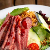 Tri Tip Salad · sliced tri-tip, mixed greens, red onion, cherry tomatoes, cucumber, avocado and
onion straws