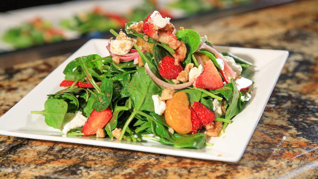 Strawberry & Mandarin Orange Spinach Salad · Strawberries, mandarin oranges, laura chenel goat cheese, red onions, toasted almonds & baby spinach served with strawberry balsamic vinaigrette.