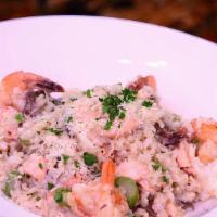 Seafood Risotto · Homemade risotto served with sautéed shrimp, salmon, mushrooms and asparagus.