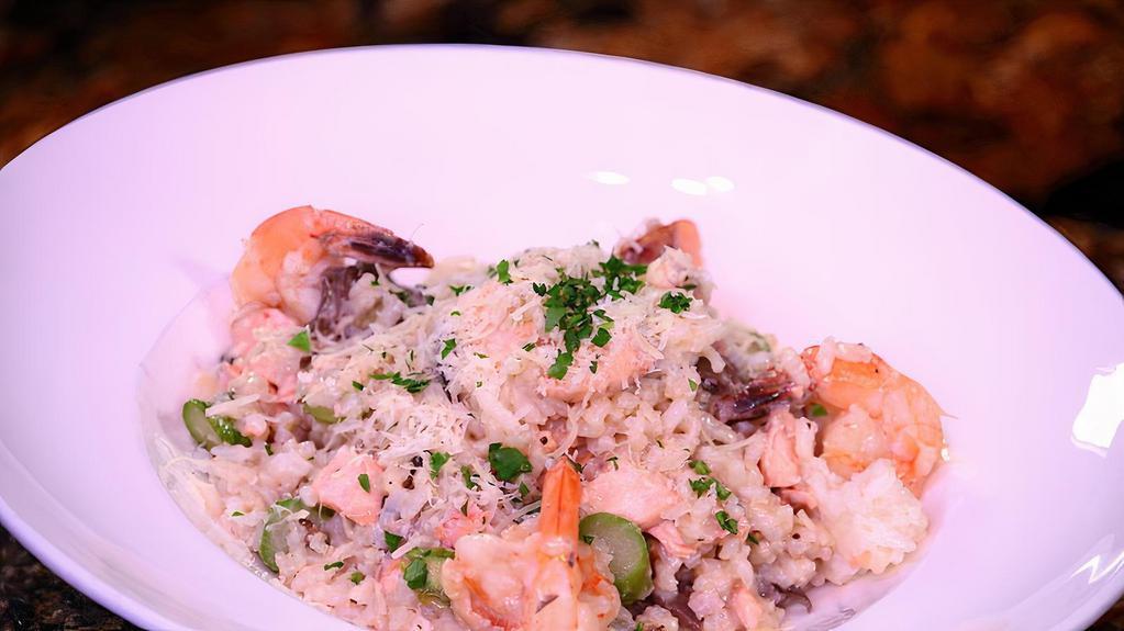 Seafood Risotto · Homemade risotto served with sautéed shrimp, salmon, mushrooms and asparagus.