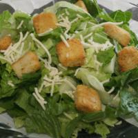 Caesar Salad · Romaine lettuce and croutons tossed in our homemade caesar dressing. Topped with grated Parm...