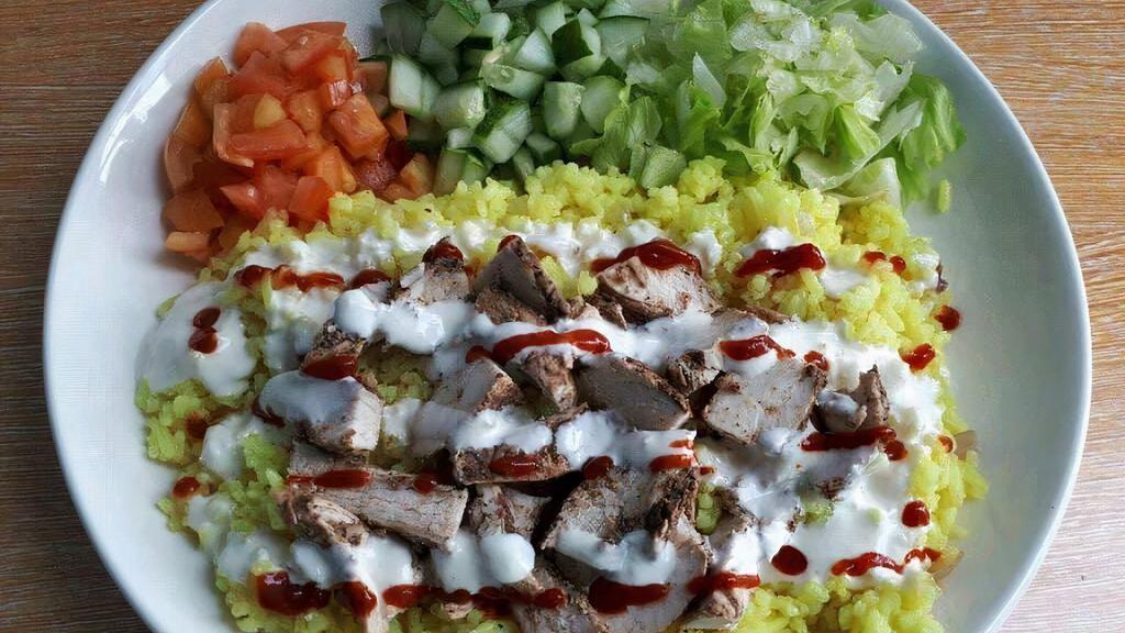 Chicken Shawarma Rice Platter · Chicken shawarma served with rice, salad, pita bread, and your choice of sauce.