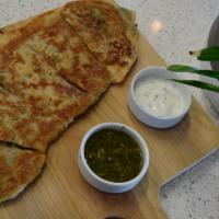 Bolani · Stuffed flat bread, filled with chopped leeks and potatoes, seasoned with cilantro and other...