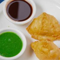 Vegetable Samosa (2 Pieces) · Deep fried patties stuffed with mildly spiced potatoes and peas.