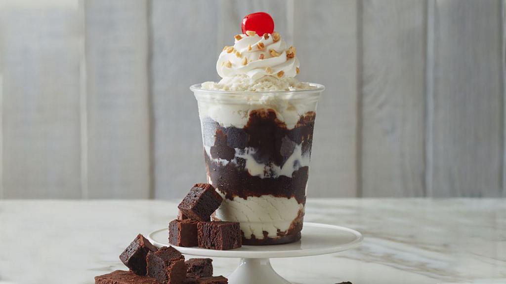 Fudge Brownie Delight Sundae · Vanilla ice cream, fudge brownies, hot fudge, whipped cream, chopped peanuts, and cherry.