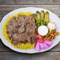 Beef Shawarma Plate · Sam's classic beef shawarma slices bedded on fresh cooked rice, salad, chef's sauce and side...