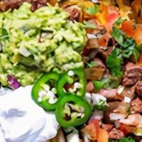 Carne Asada Fries · Fries with carne asada, melted cheese topped with sour cream and guacamole.