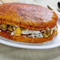 Pambazo · Torta covered in red enchilada sauce filled with potatoes, chorizo, lettuce, queso fresco, a...
