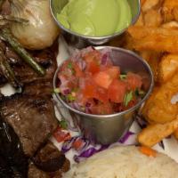 Carne Asada · Charbroiled steak thinly sliced. Served with guacamole salad, rice, beans and flour tortillas.