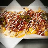 Loaded Nachos · (Tortilla chips, topped with nacho cheese, choice of meat, refried beans, grilled onion, pic...