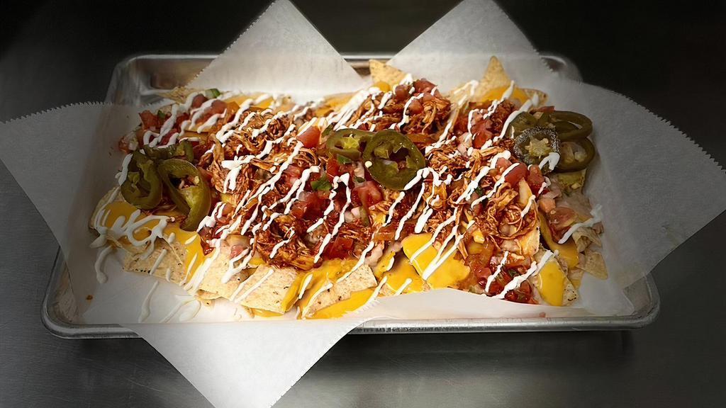 Loaded Nachos · (Tortilla chips, topped with nacho cheese, choice of meat, refried beans, grilled onion, pico de gallo, sour cream & jalapenos).