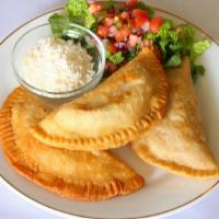 Empanada · (Deep fried corn flour filled with choice of meat, then topped with lettuce, pico de gallo, ...
