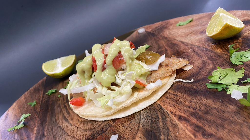 Fish Taco · (Corn tortilla, fried fish, cabbage, pico de gallo, lime & avocado salsa).