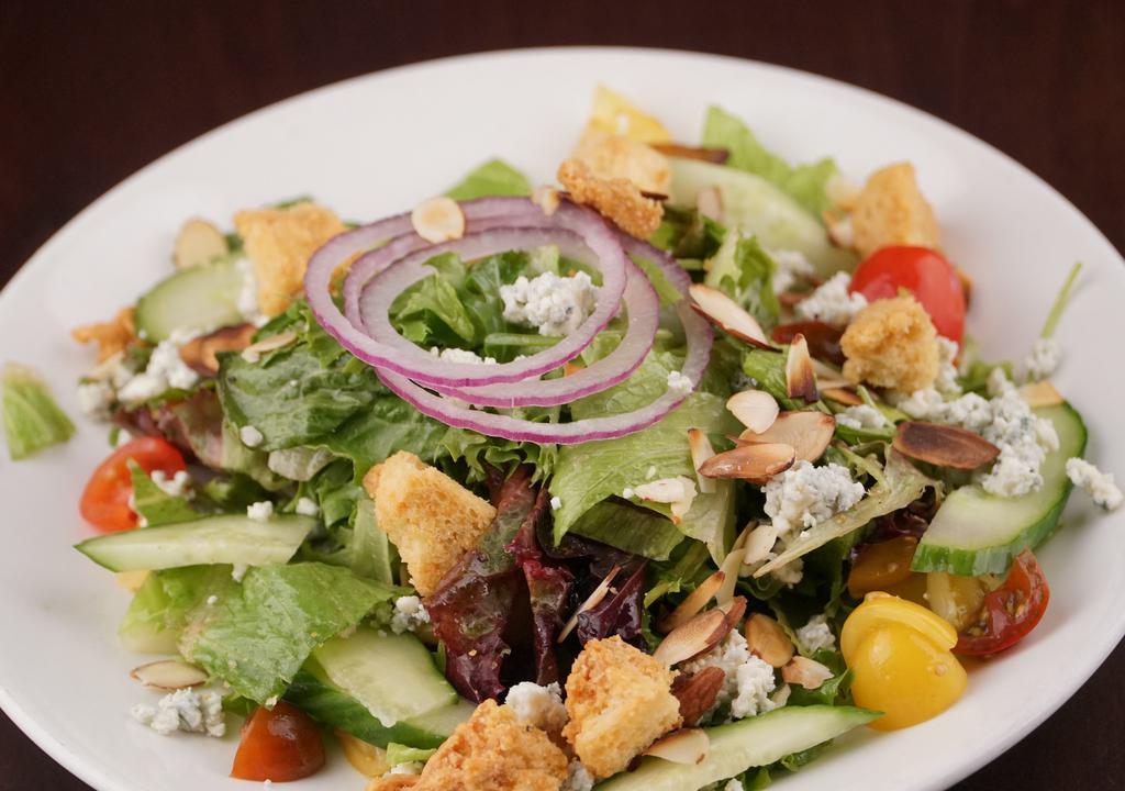 Verde · Mixed greens, cucumbers, tomatoes, onions, dry bleu cheese, roasted almonds, garlic croutons, red wine vinaigrette.