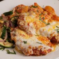 Chicken Parmigiano · Breaded Chicken breasts, mozzarella, marinara, pasta, seasonal vegetables.