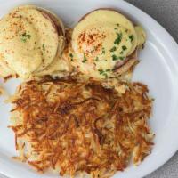 Eggs Benedict · Two poached eggs and Canadian bacon on an English muffin and topped with a rich hollandaise ...