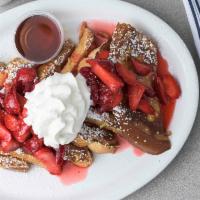 French Toast · Three slices of French toast topped with powdered sugar and served with butter and warm mapl...