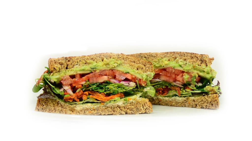 Supreme Veg Out Sandwich  · avocado, crispy carrots, sunflower seeds, red onion, tomato, cucumber, red leaf lettuce, sunflower sprouts, tofu spread on whole wheat bread