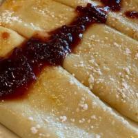Swedish Pancakes · 3 Swedish Pancakes topped with powder sugar and lingonberry
