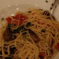 Pasta Promodoro · Cappelini tossed with olive oil, fresh herbs, garlic, mushroom, sun dried tomatoes, basil an...