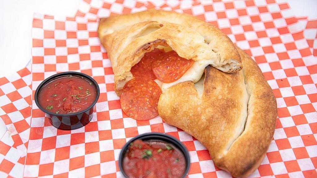 Calzone · Fried, stuffed pizza dough, mozzarella, ricotta, served with side of marinara. Choice of toppings.