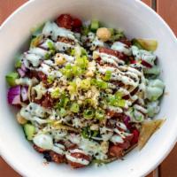 Poke Bowl · Ahi poke with chopped macadamia nuts and dices veggies over rice, drizzled with wasabi aioli.