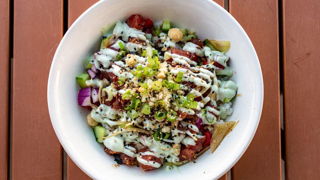 Poke Bowl · Ahi poke with chopped macadamia nuts and dices veggies over rice, drizzled with wasabi aioli.