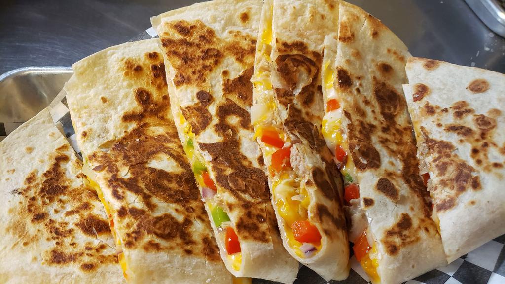 Quesadilla · Flour tortilla with cheese blend and your choice of chicken or carnitas.