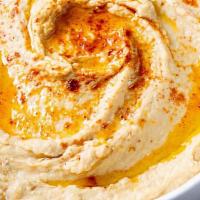 Hummus · Puree garbanzo beans, sesame seed, tahini mixed with a touch of olive oil, lemon and spices.