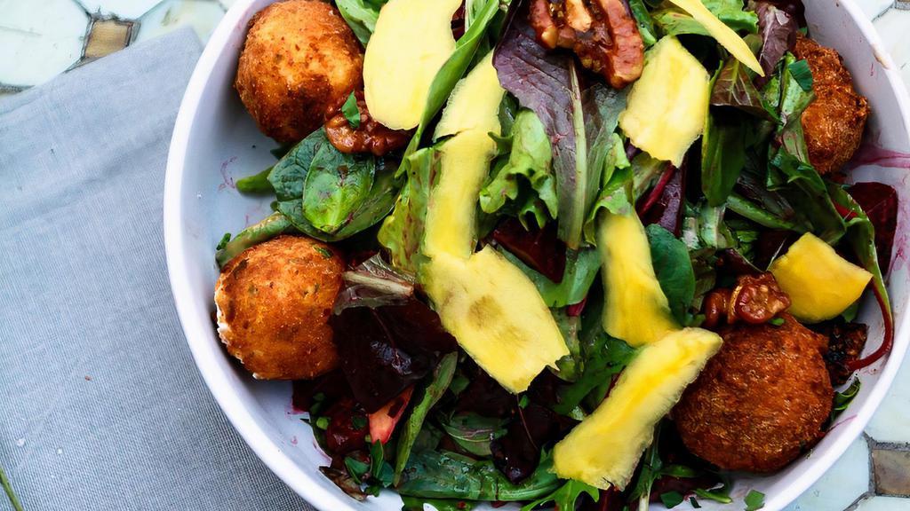 Goat Cheese Salad · Vegan. Fried Goat cheese, organic baby greens, fresh mango, fresh red beets and caramelized walnuts served with balsamic vinaigrette.