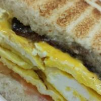 Breakfast Sandwich · 2 scrambled eggs, cheese, and a choice of ham, bacon, or sausage.