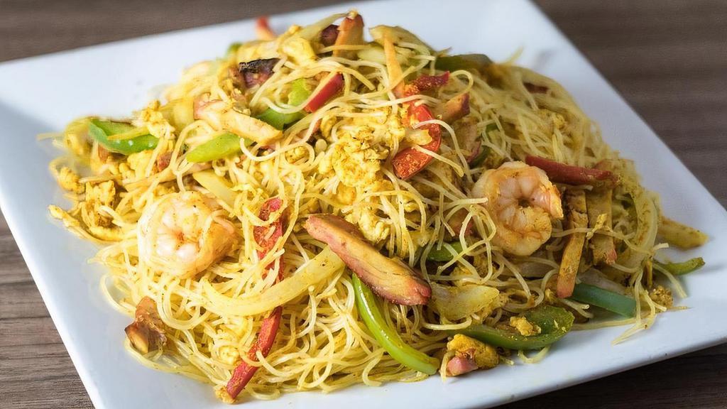 Singapore Noodles · Vermicelli Rice noodles, Shrimp and BBQ Pork stir-fried with flavorful curry spices with eggs, bell peppers, and onions.