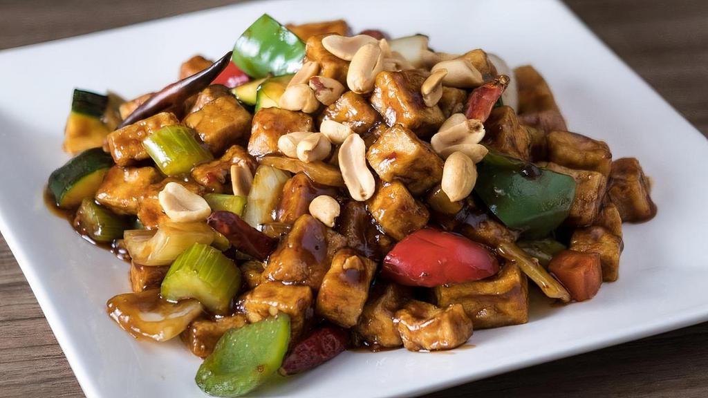 Kung Pao Tofu · Diced zucchini, carrots, onions, bell peppers and water chestnuts stir-fried with Tofu in our savory spicy brown sauce, then topped with peanuts.