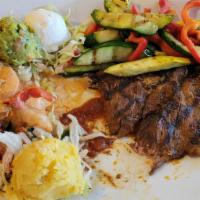 Asada Y Camaron Mezcal · Our Choice Angus steak paired with plump shrimp al mezcal in a large skillet. Served with pa...