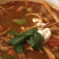 Chicken Tortilla Soup · Hearty chicken broth with grilled chicken and vegetables, topped with cheese mix, tortilla s...
