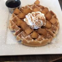 Cinnamon Crusted French Toast (2) · Slices of French toast topped with nutella, bananas, powdered sugar, and whipped cream.