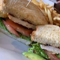 Chicken Breast Sandwich · A tasty chicken breast served with lettuce, tomato, onions, pickles, on a hamburger bun.