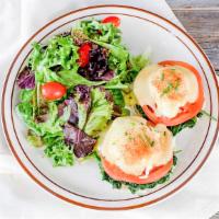 Egg Benedict · Two eggs poached on a toasted pancakes with ham and hollandaise, salad.