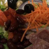 House Salad · Romaine lettuce topped with olives, cucumber, carrots, roasted red bell peppers, kidney bean...